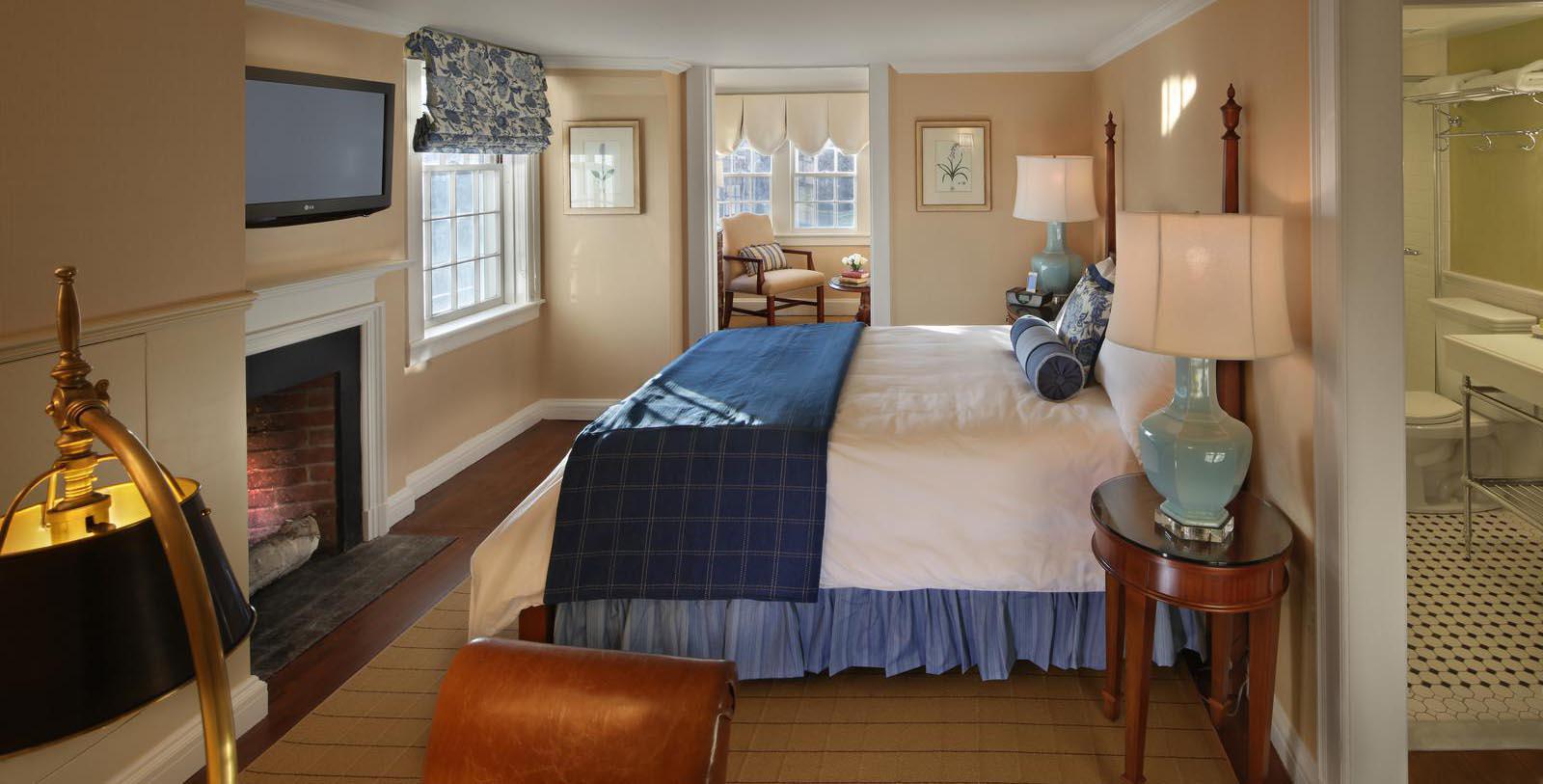 a bedroom with a bed and a fireplace