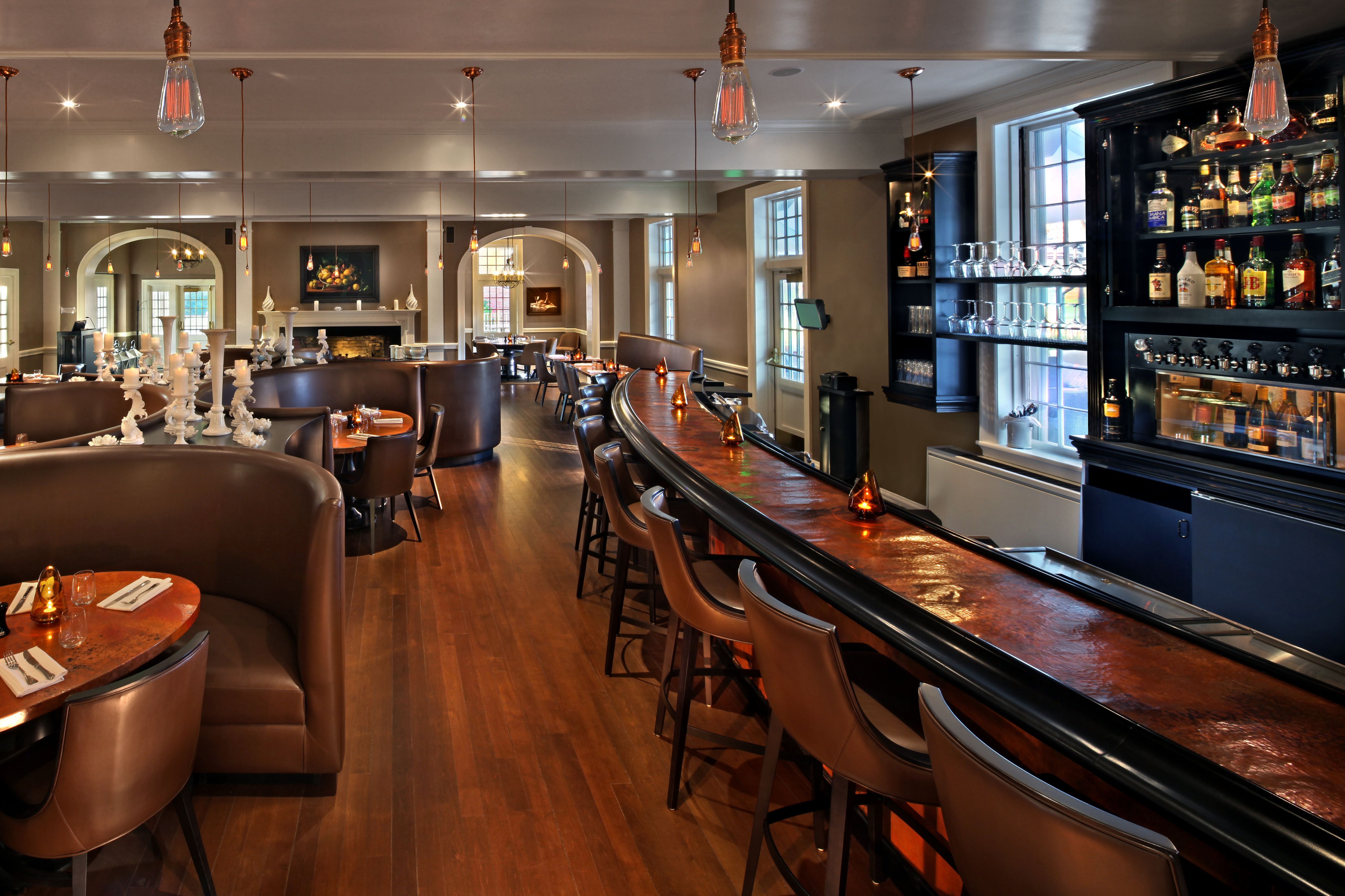 a room with a bar and chairs