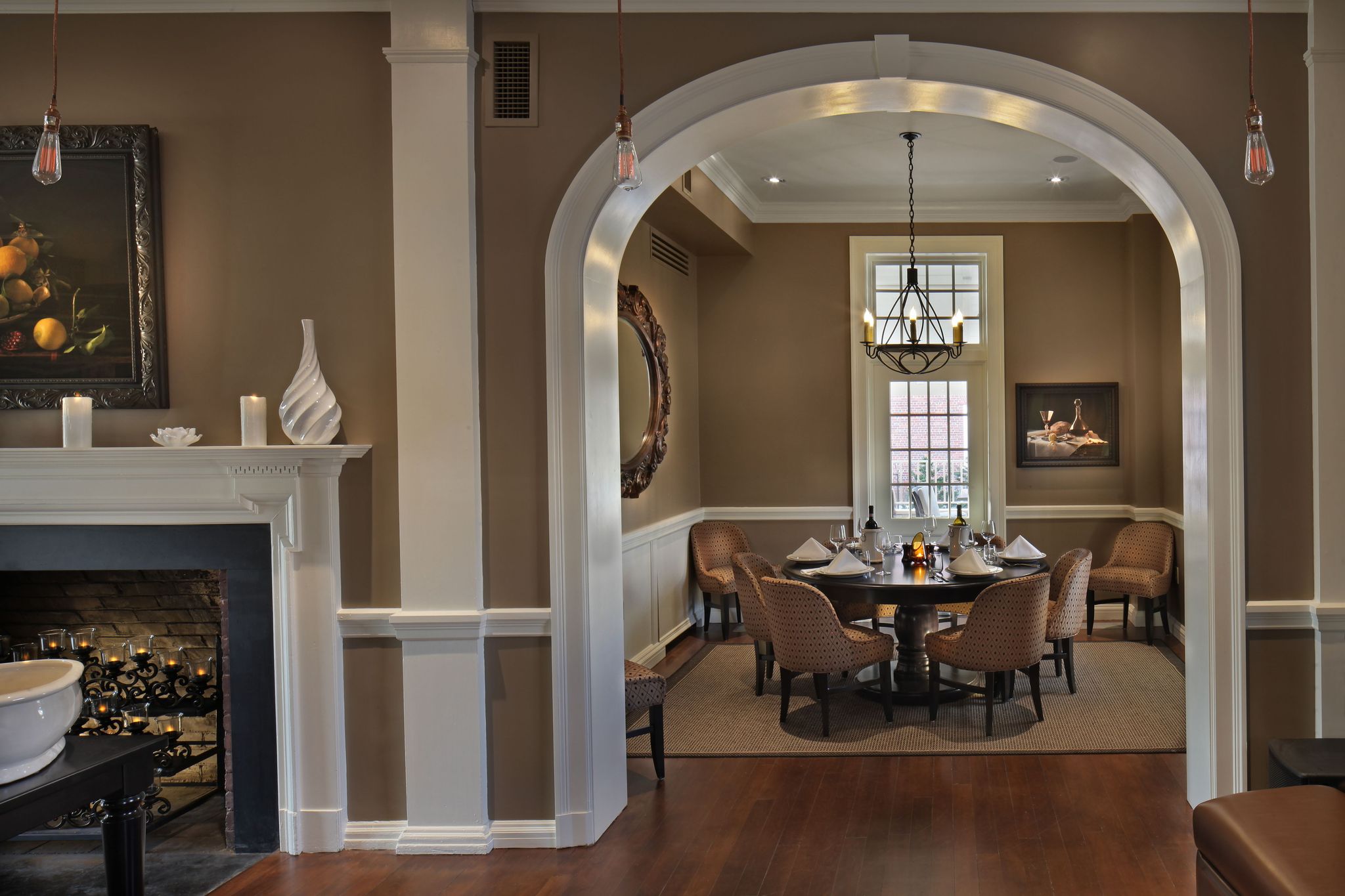 a dining room with a fireplace and a round table