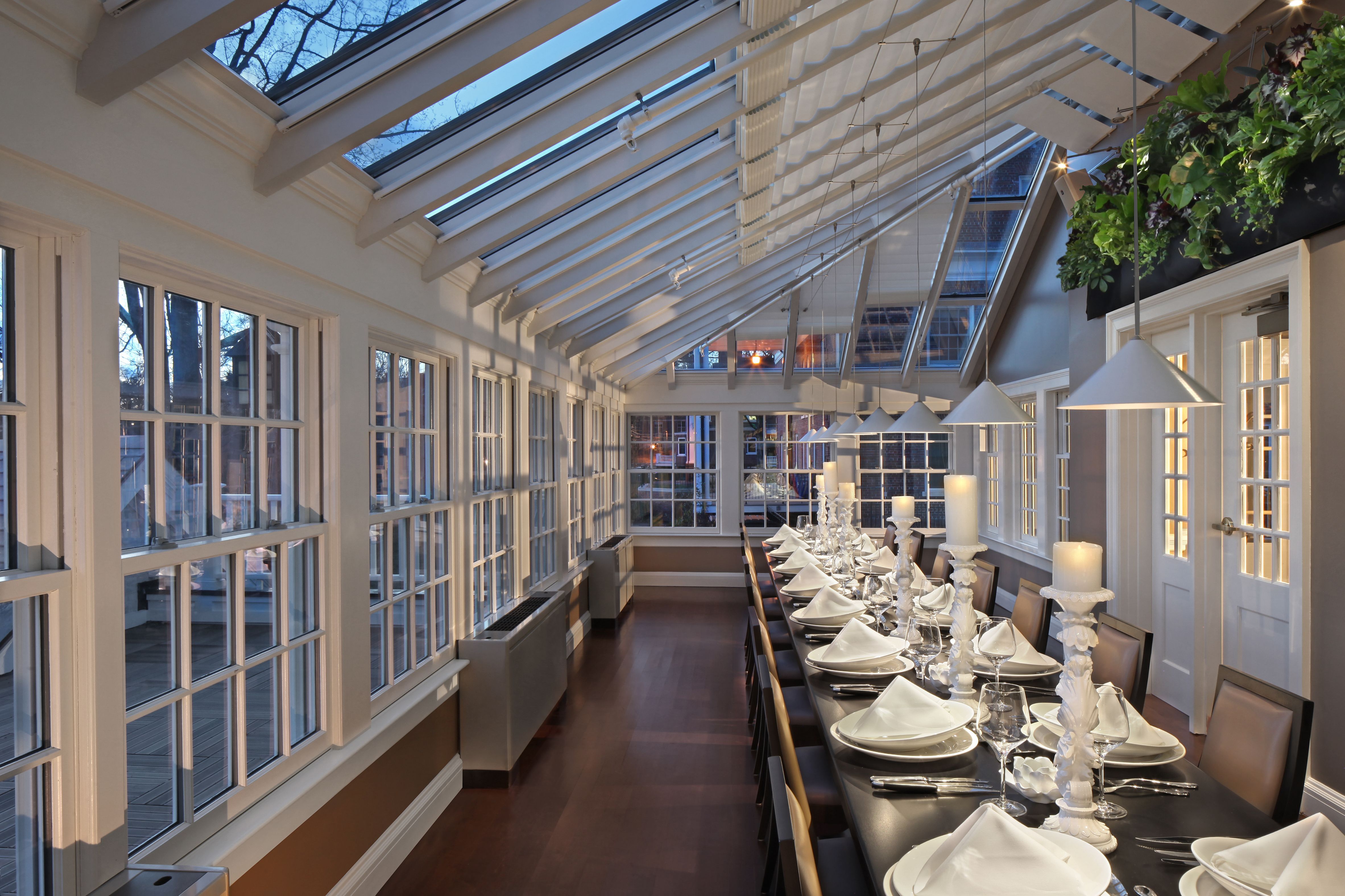 a long table with plates and candles on it
