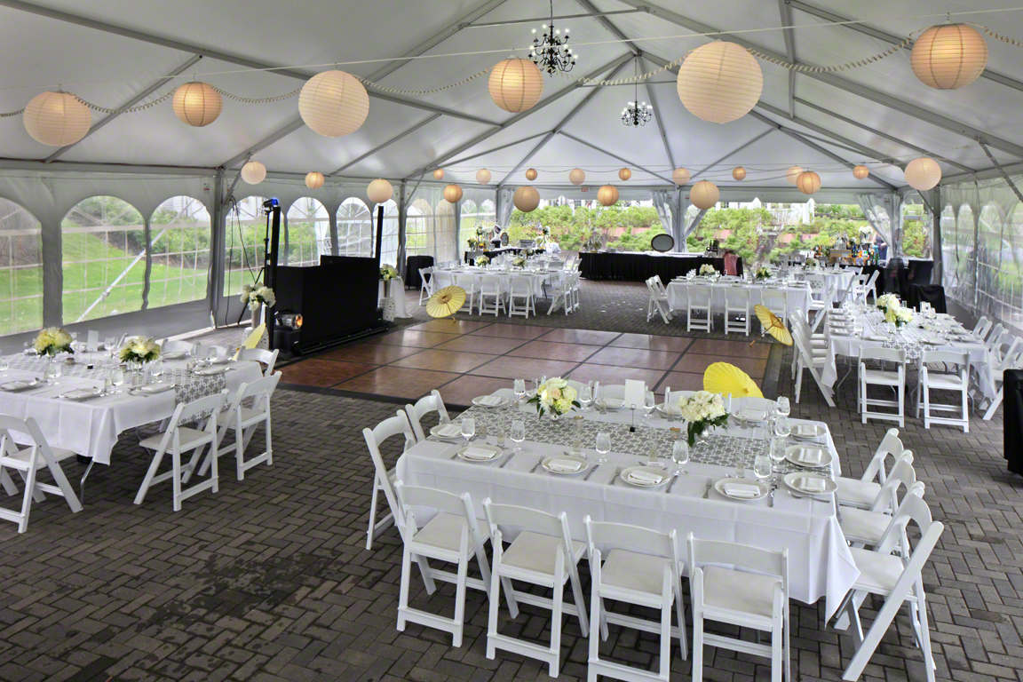 a large tent with tables and chairs