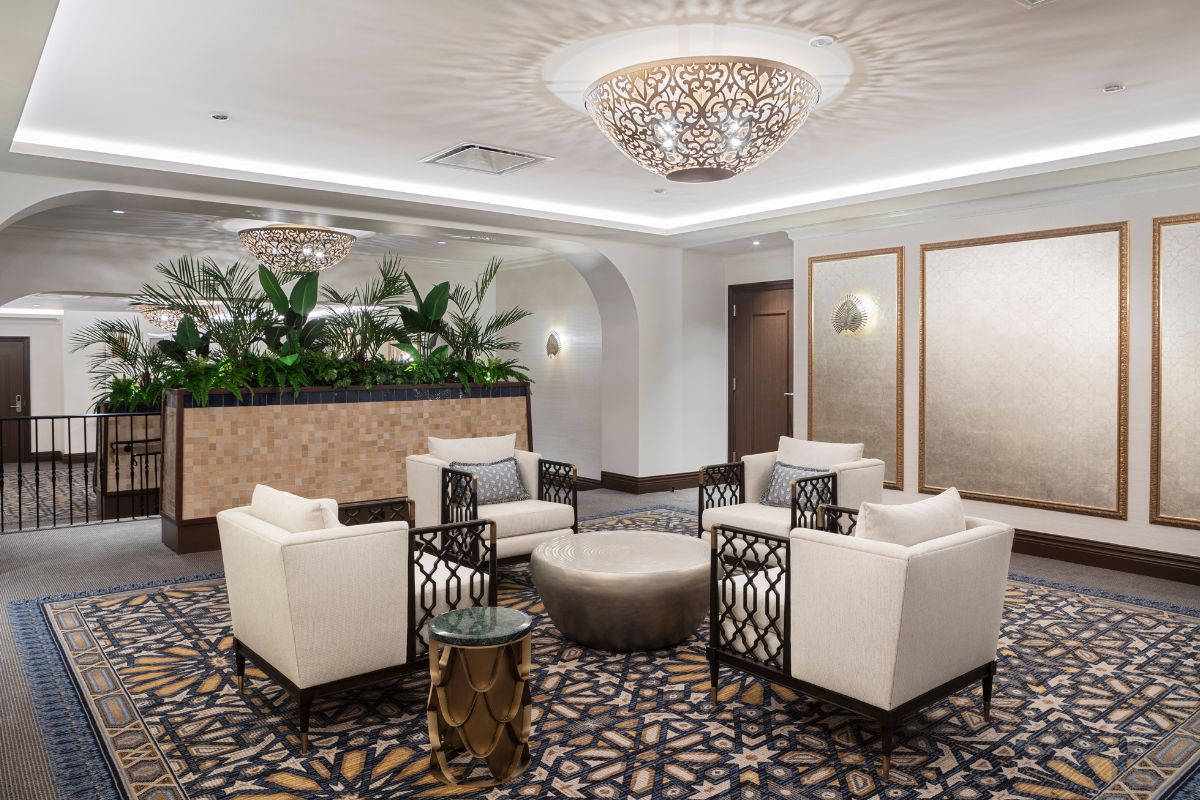 a room with white chairs and a round table