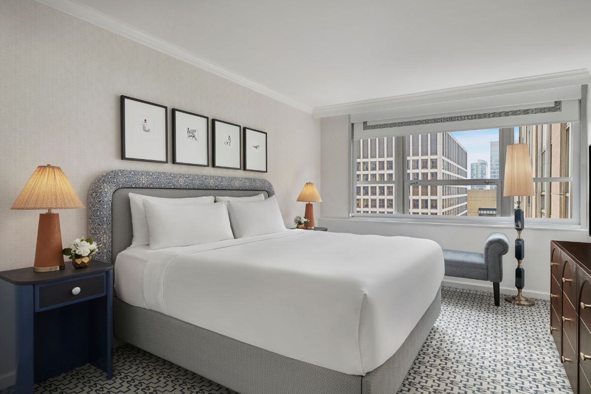 a bedroom with a bed and a chair