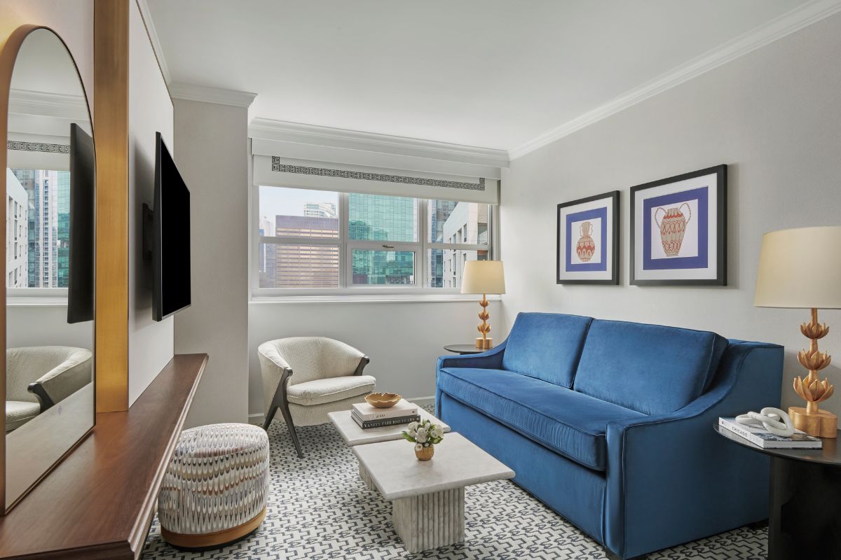 a living room with a blue couch and a tv