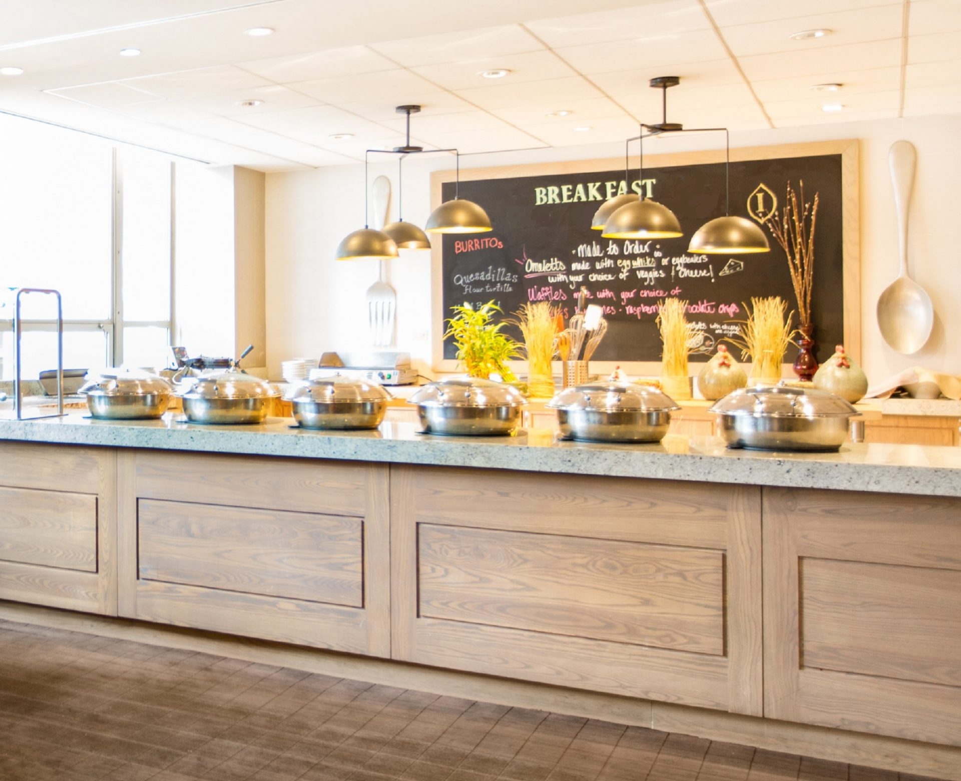 a buffet line with silver bowls on top