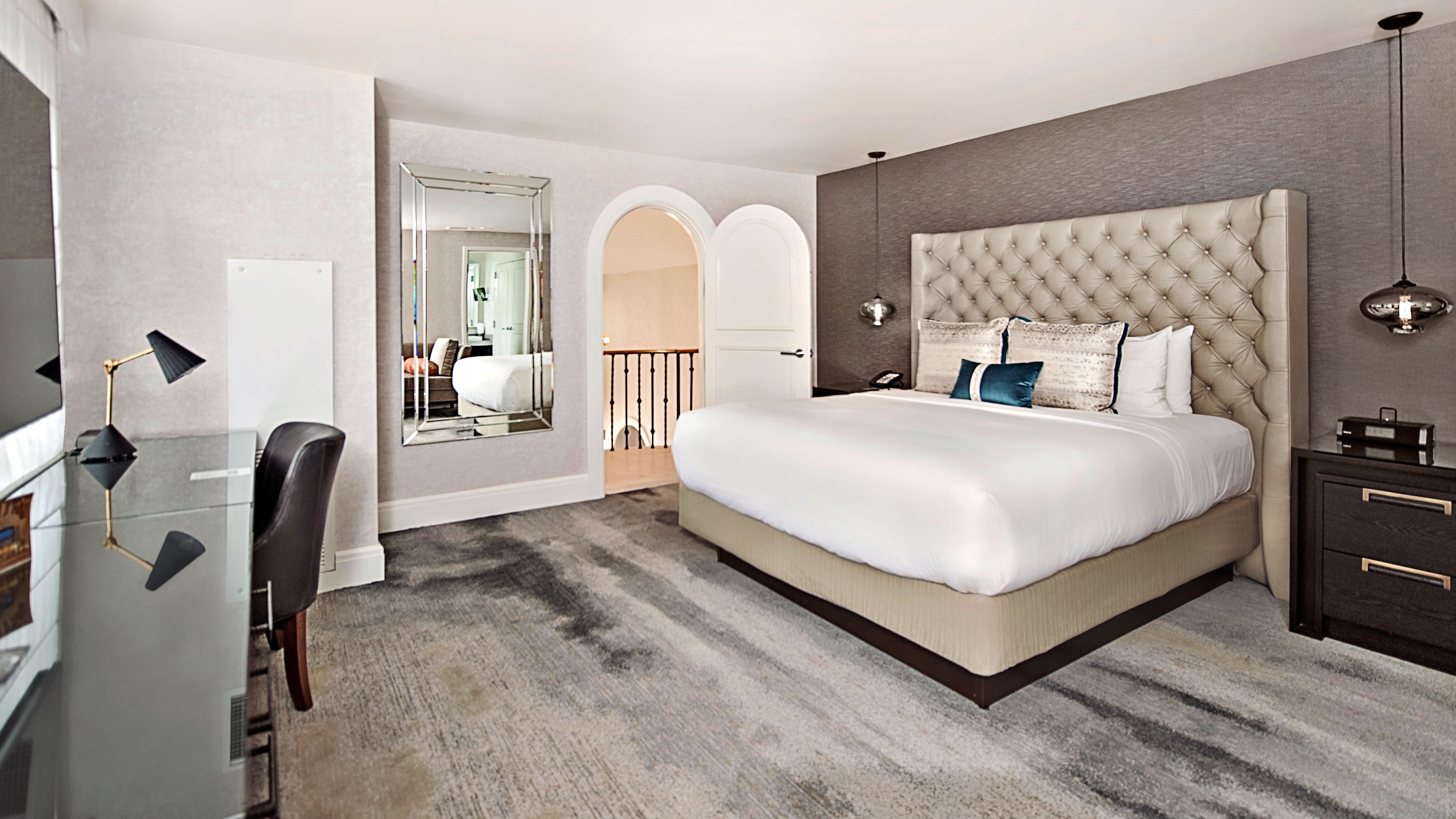 a bedroom with a bed and a mirror