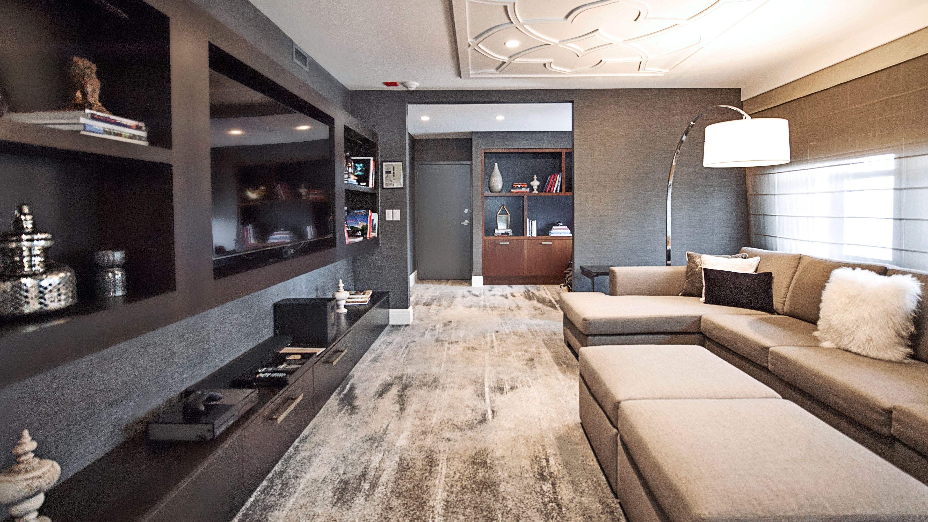 a living room with a large television and a couch