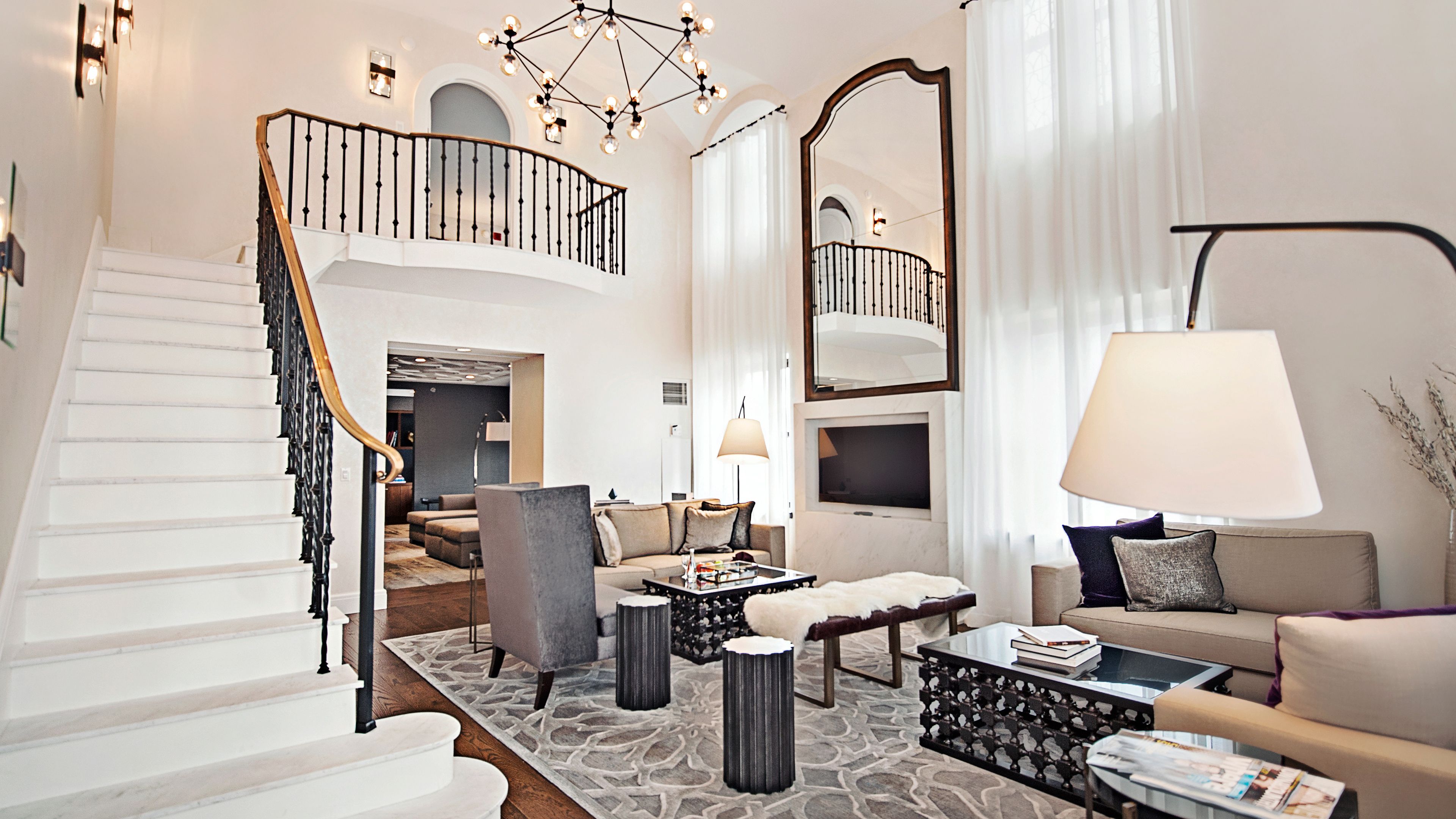 a living room with a staircase and a couch