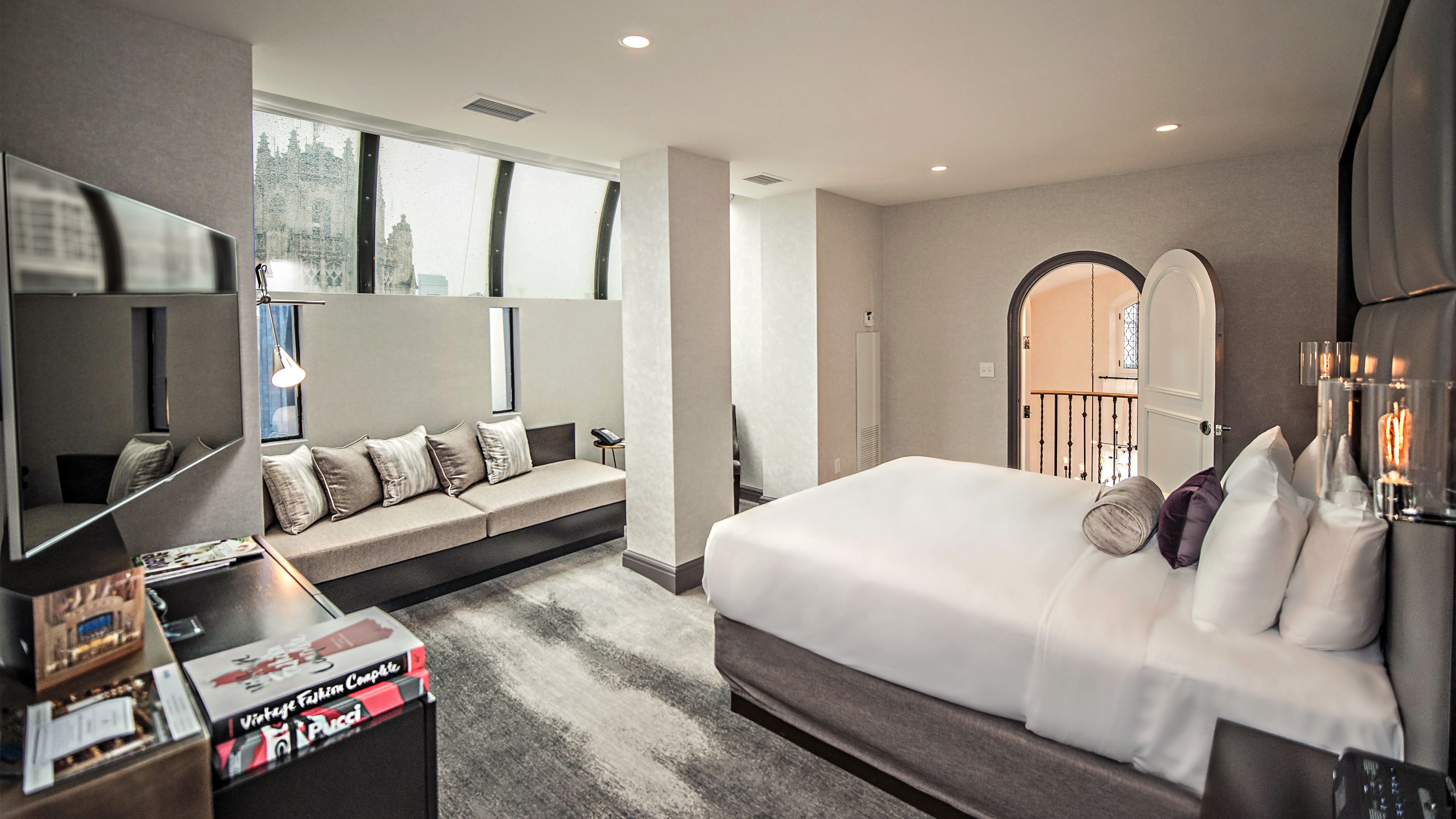 a bedroom with a couch and a tv