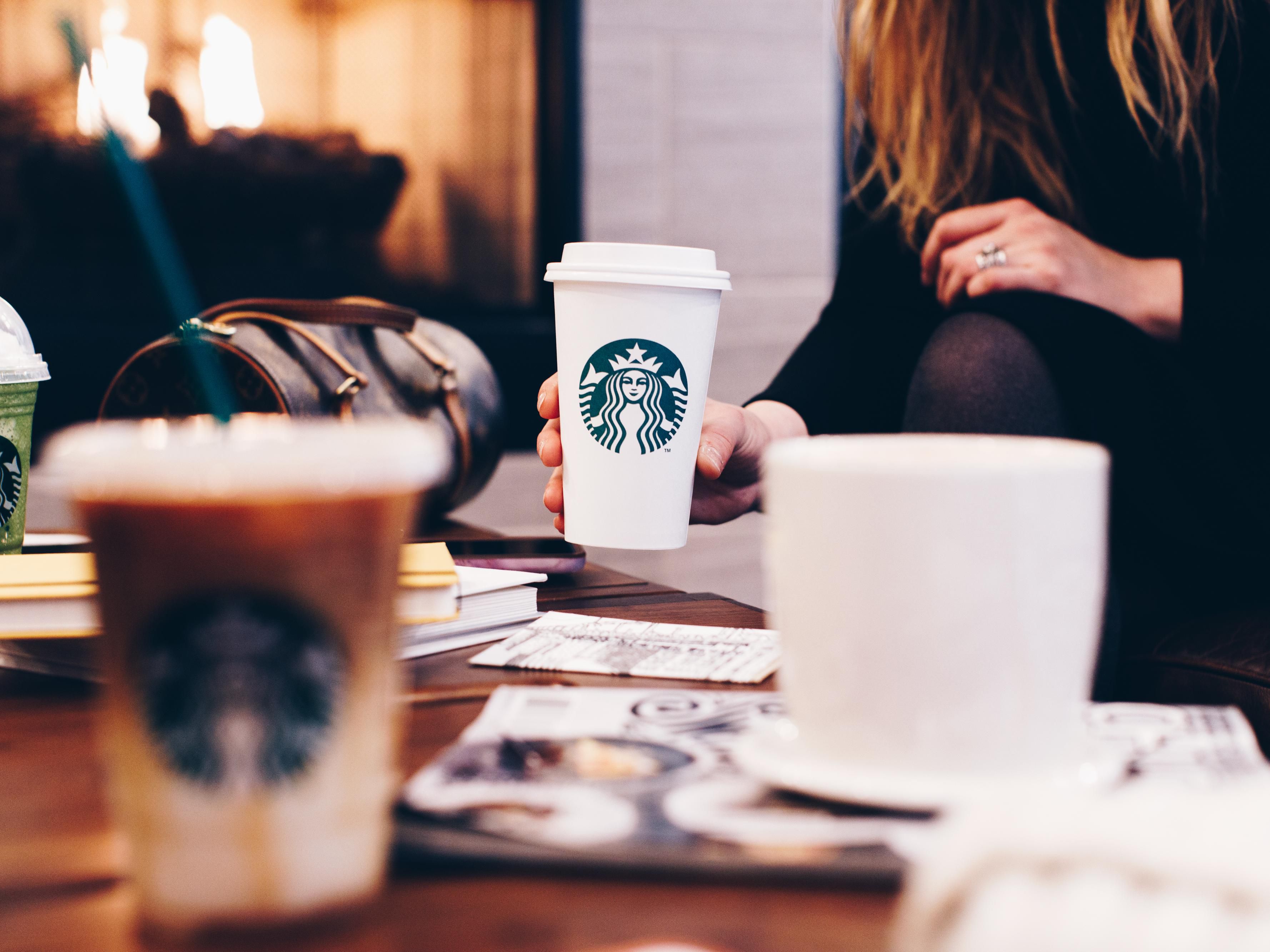 a person holding a cup of coffee