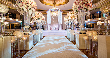 a wedding reception with a chandelier and flowers