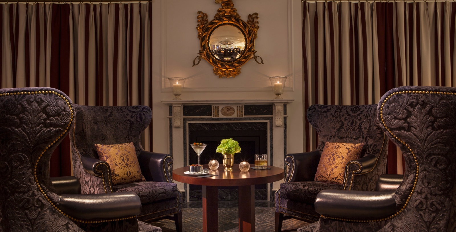 a room with a fireplace and chairs
