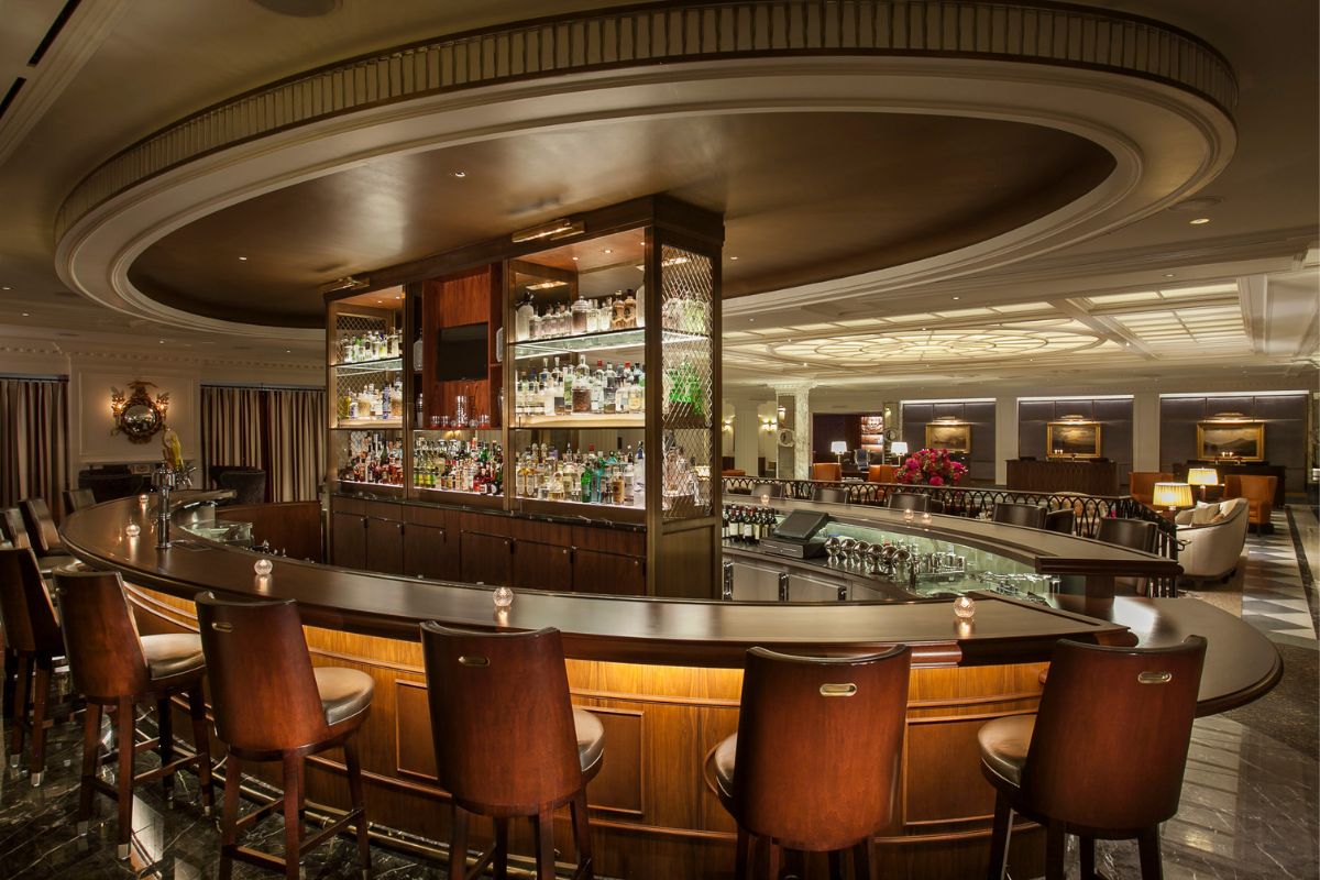 a bar with a counter and chairs