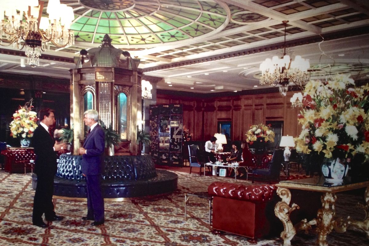 a man standing in a room with a fountain