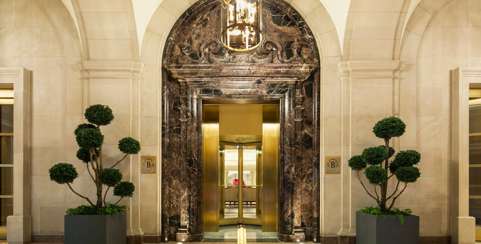 a elevator with a chandelier from the ceiling