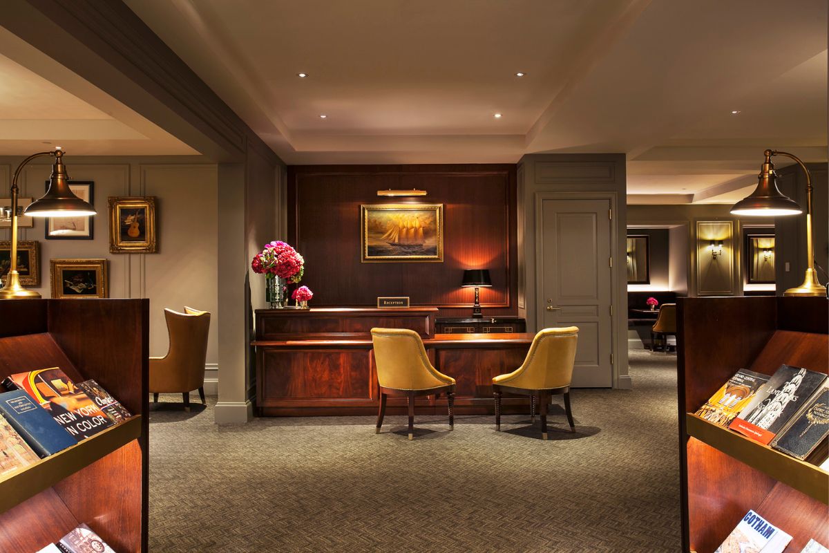 a room with a desk and chairs