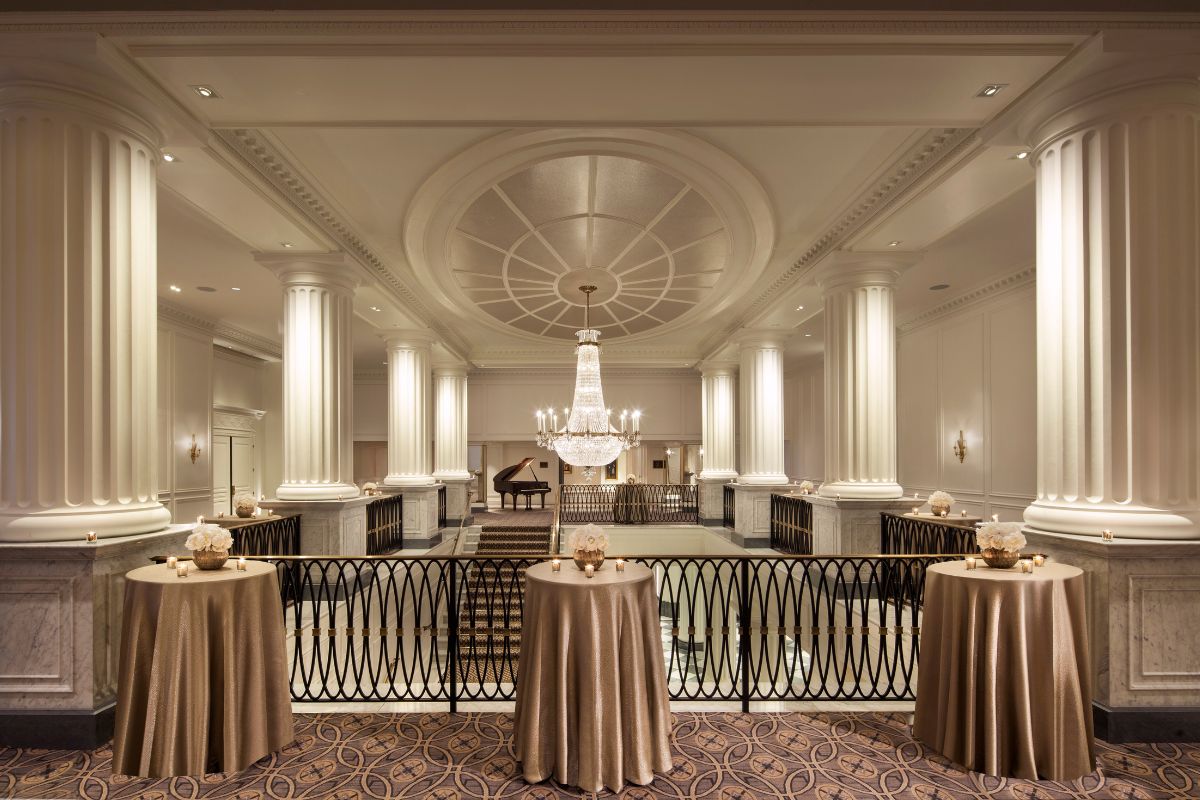 a room with tables and chandeliers