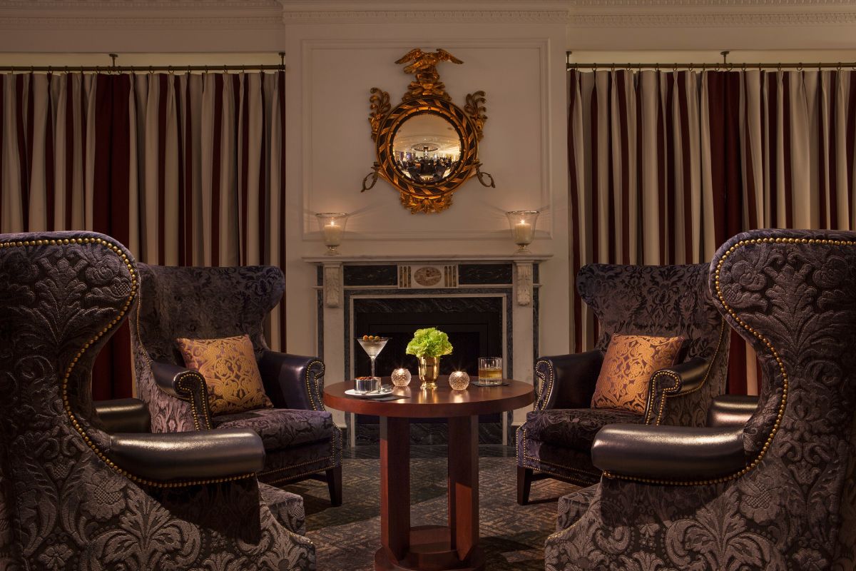 a room with chairs and a fireplace