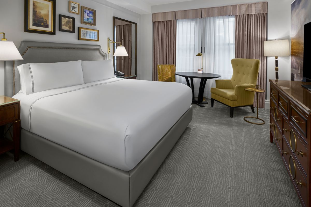 a hotel room with a bed and a table