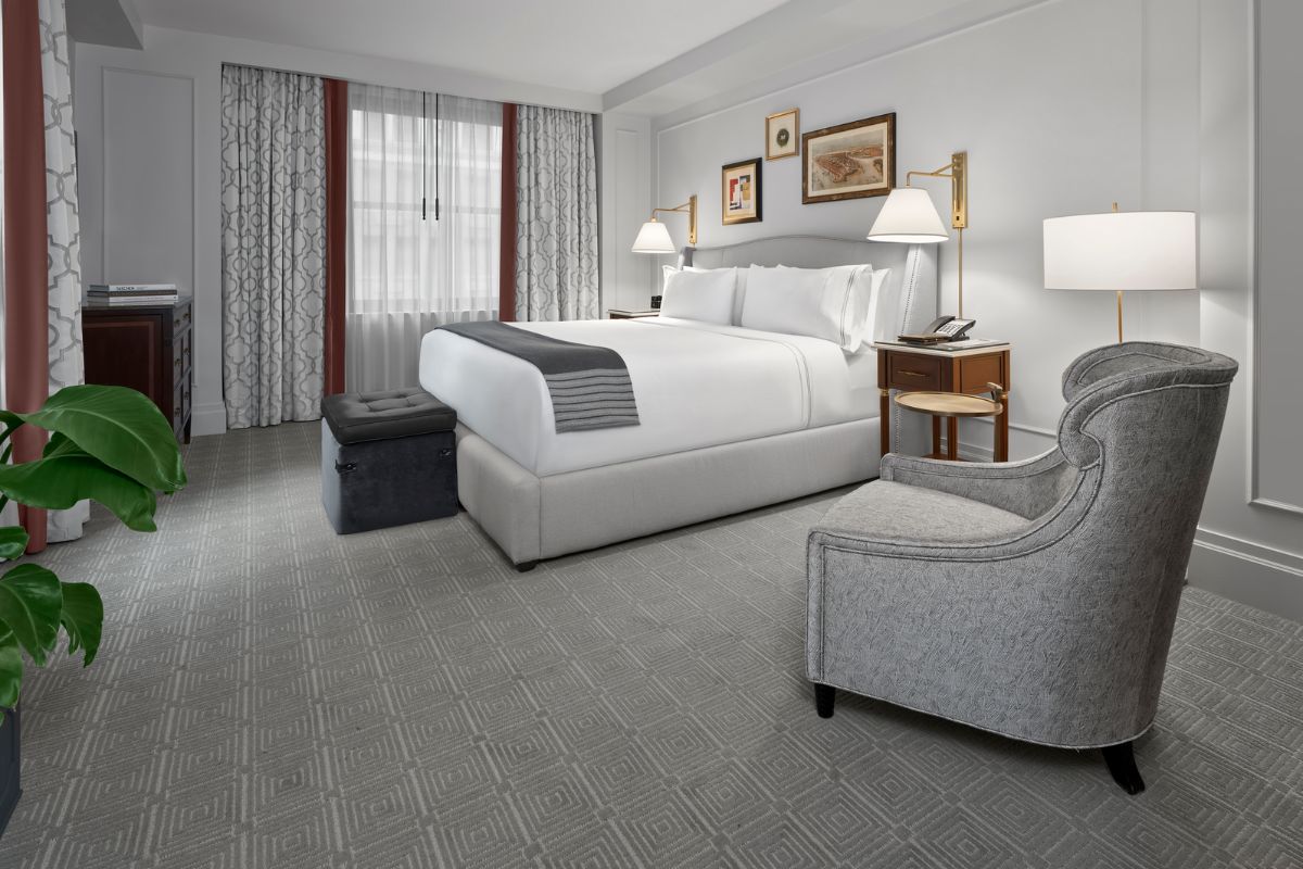 a bedroom with a bed and a chair