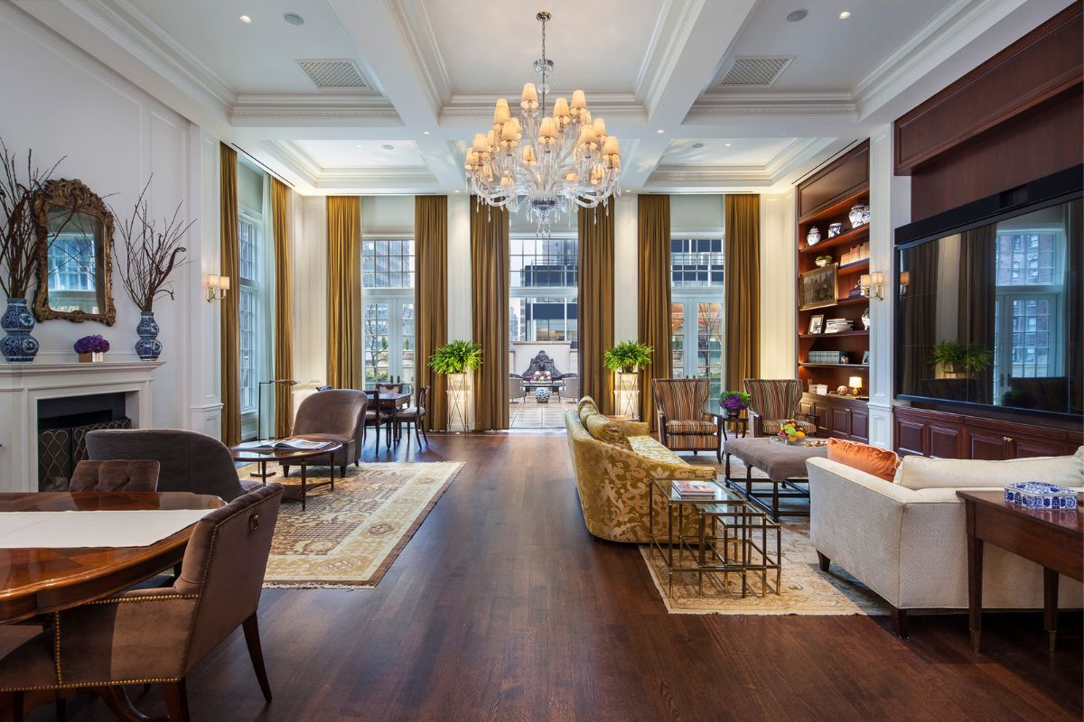 a room with a chandelier and couches
