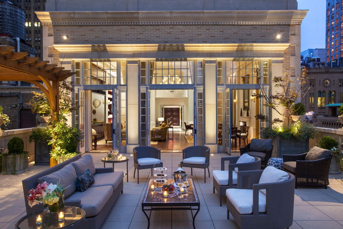 a patio area with chairs and tables