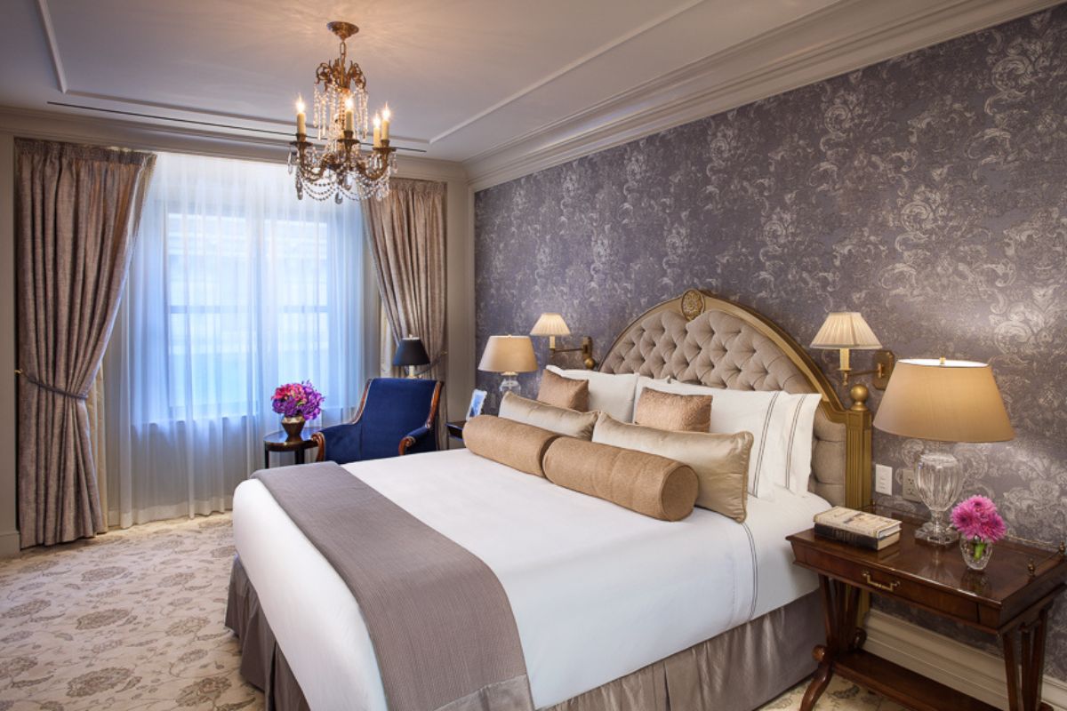 a bedroom with a bed and a chandelier