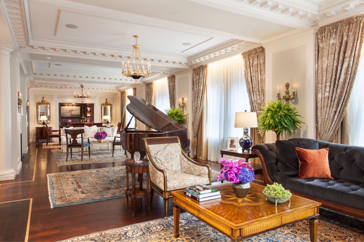 a living room with a piano and chairs