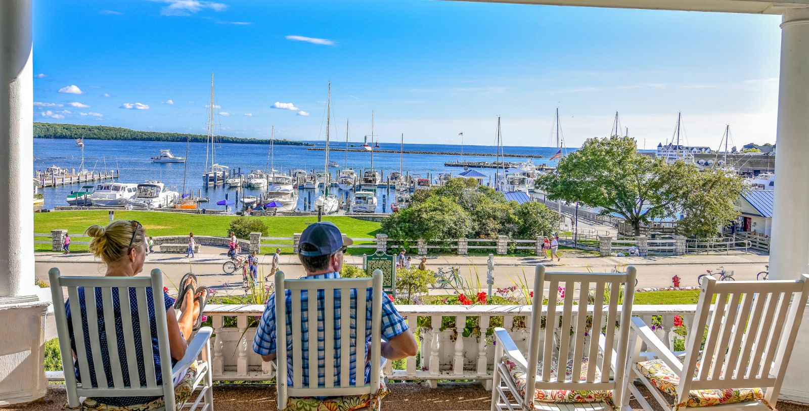 a man sitting on a porch overlooking a marina