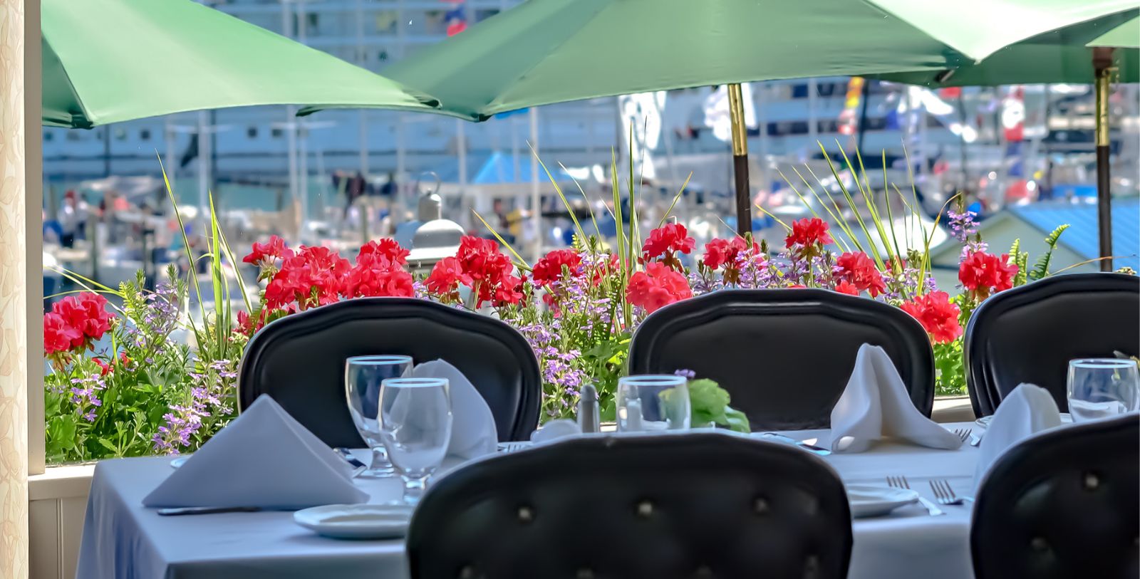 a table set up with chairs and flowers
