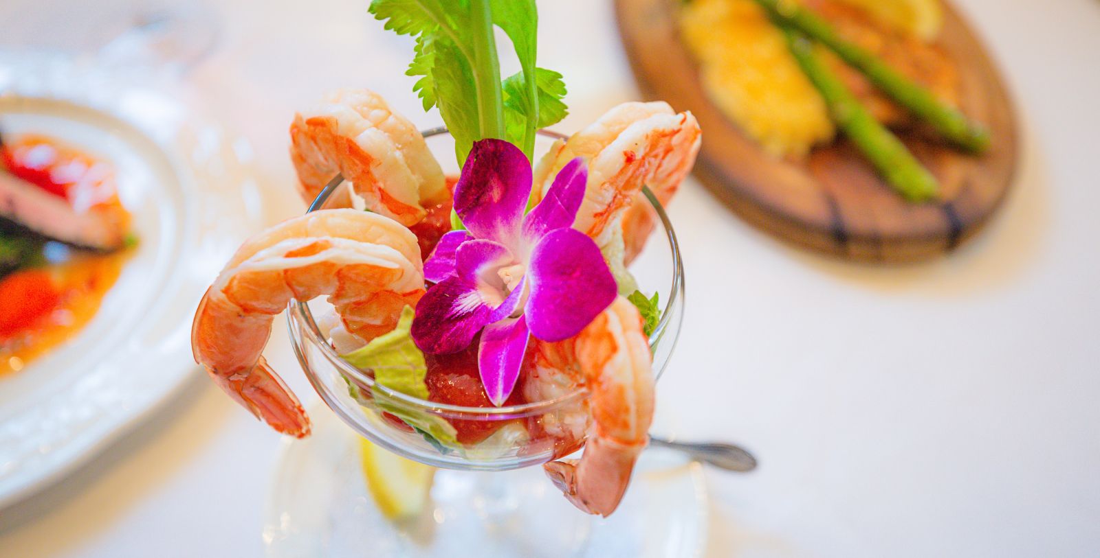 a shrimp cocktail with a flower on top