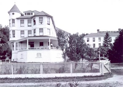 a large white house with a white fence