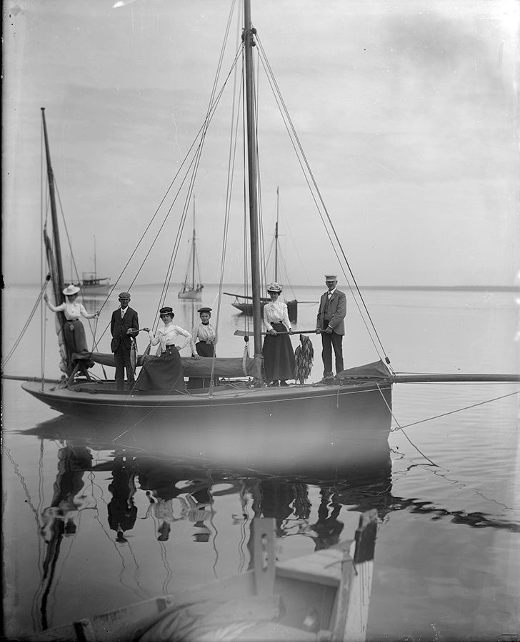 a group of people standing on a boat