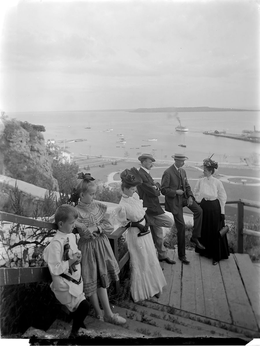 a group of people standing on a wooden stairs