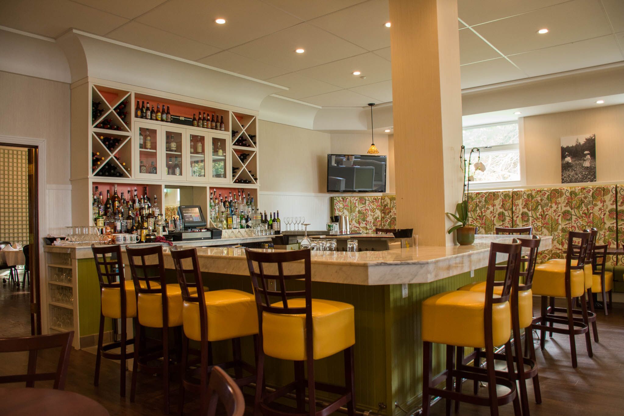 a bar with a counter and chairs