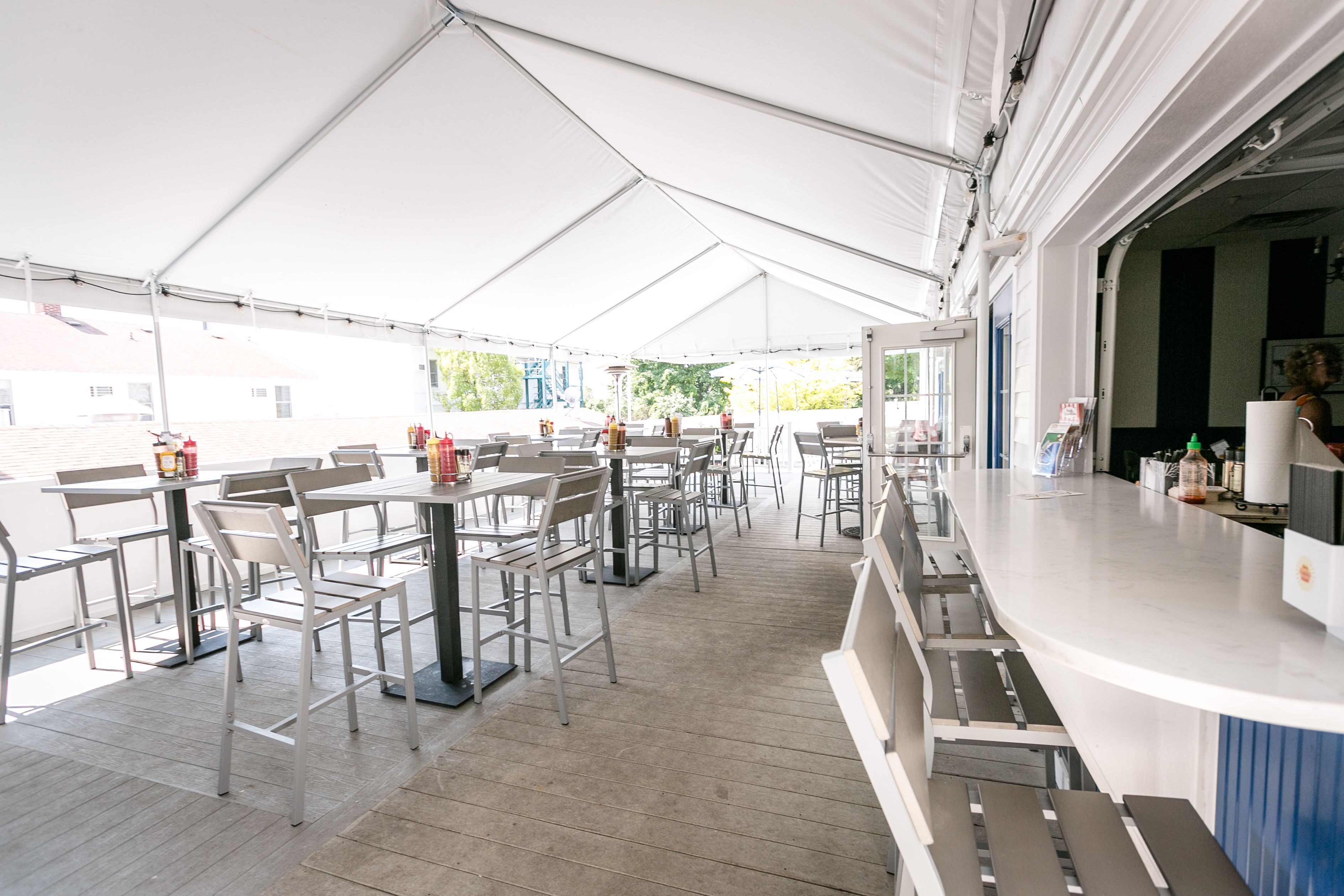 a white tent with tables and chairs
