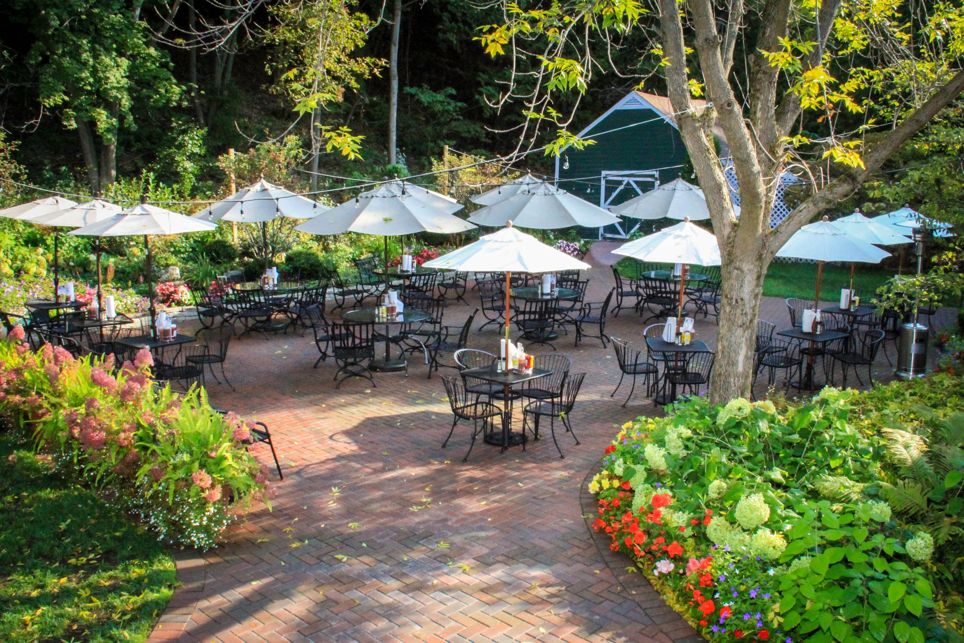 a patio with tables and umbrellas