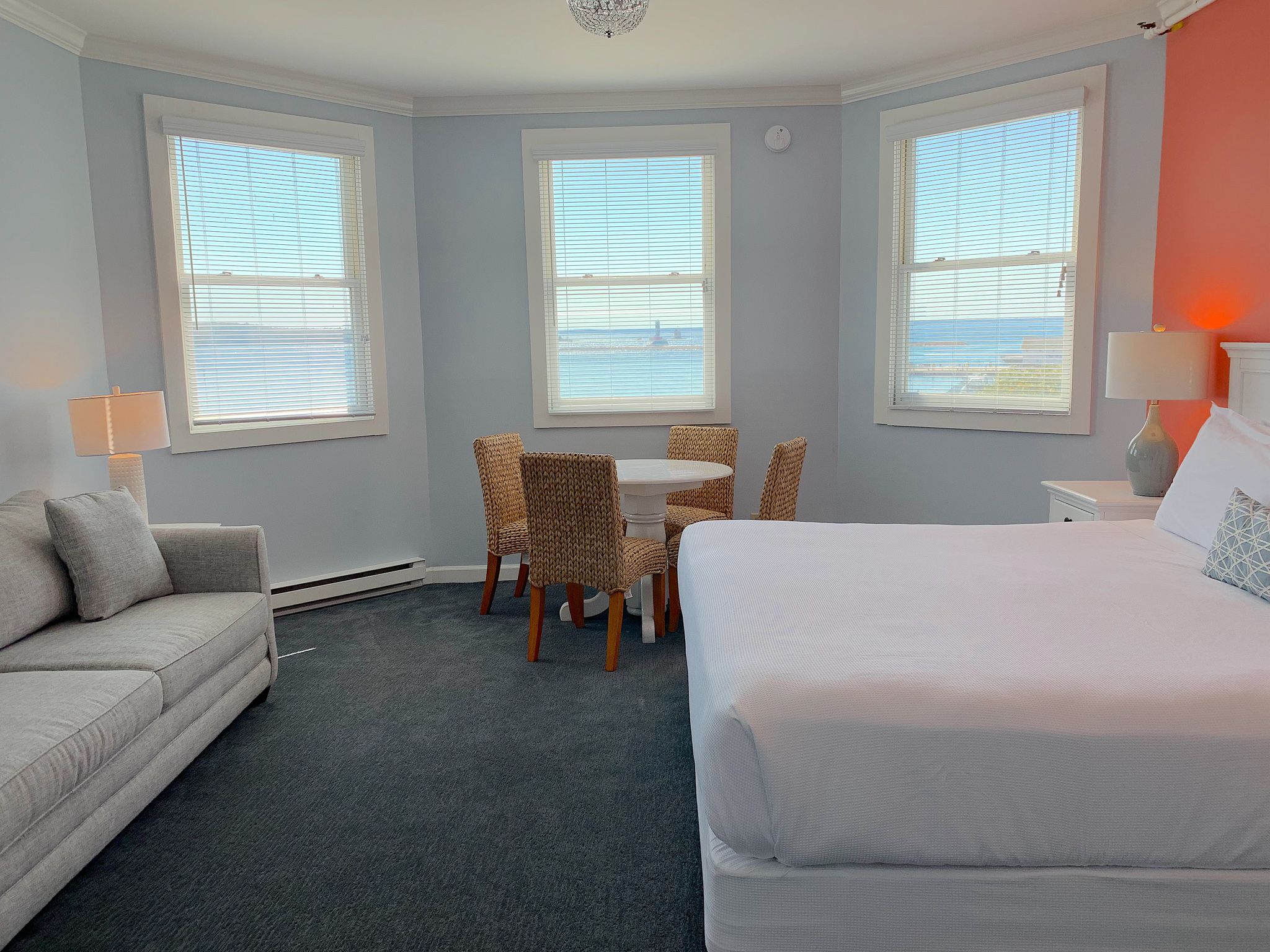 a room with a bed and a table and chairs