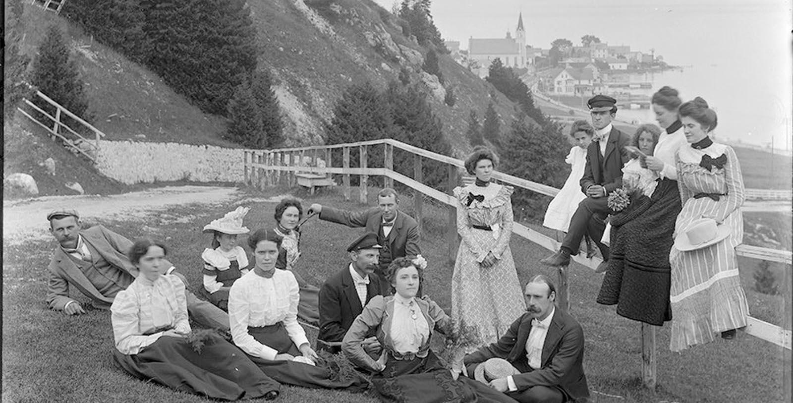 a group of people sitting on the grass