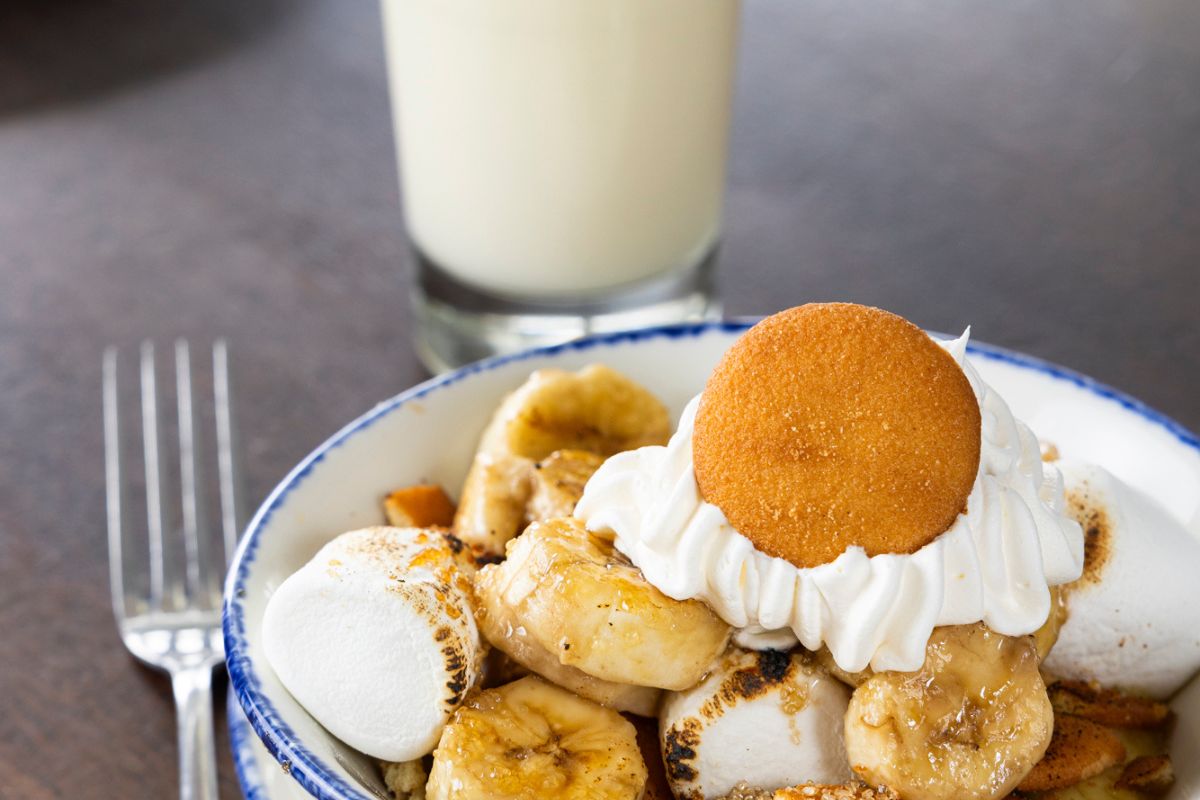 a bowl of banana split with marshmallows and a cookie on top
