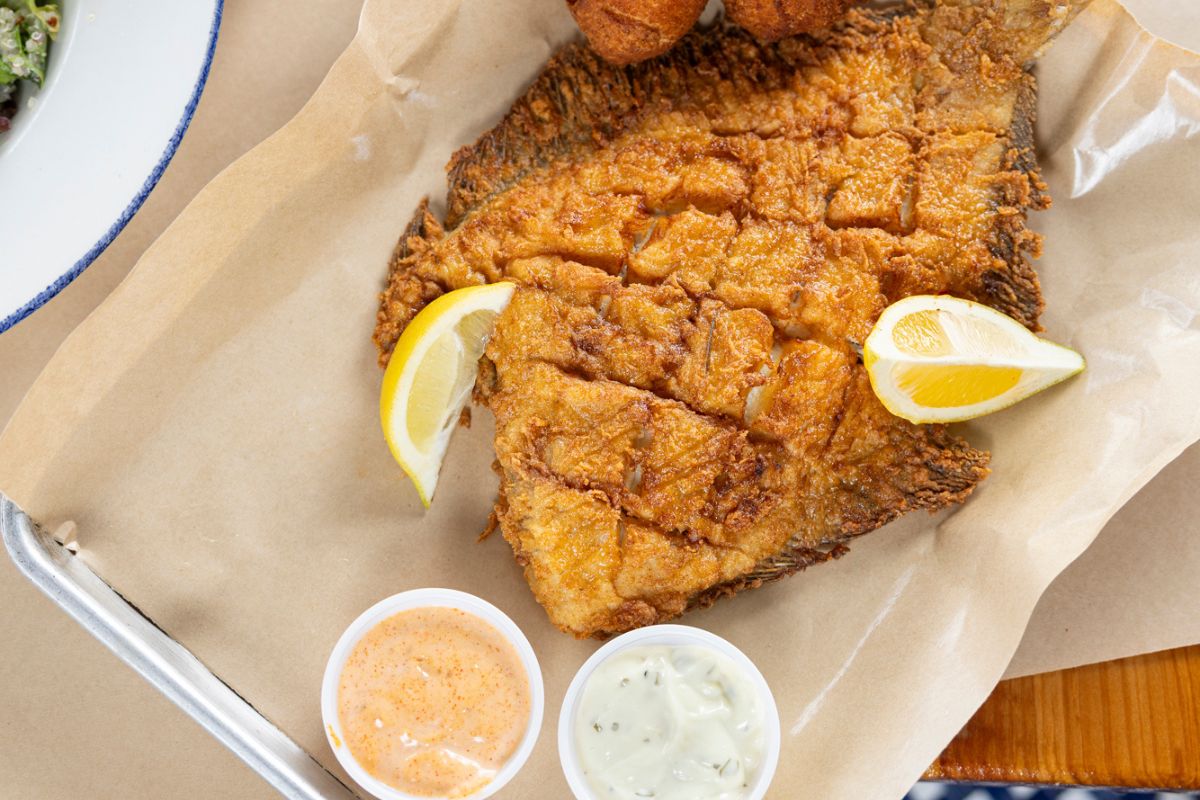 a plate of fried fish with sauces