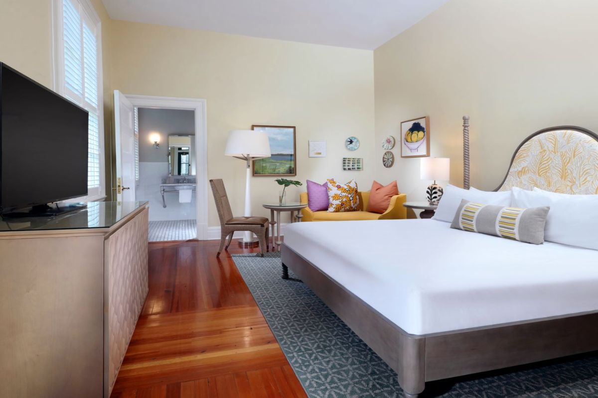a bedroom with a bed and a table and chairs