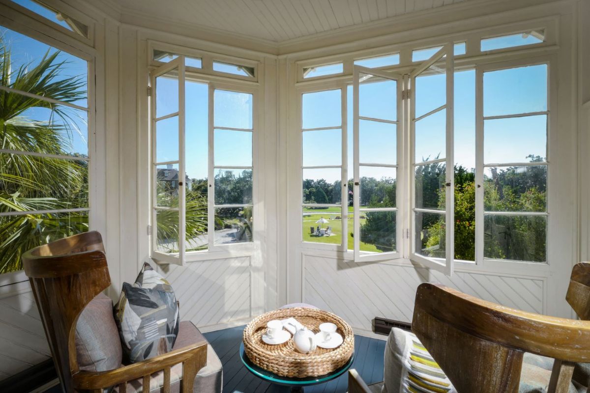 a room with a table and chairs and a table with a basket on it