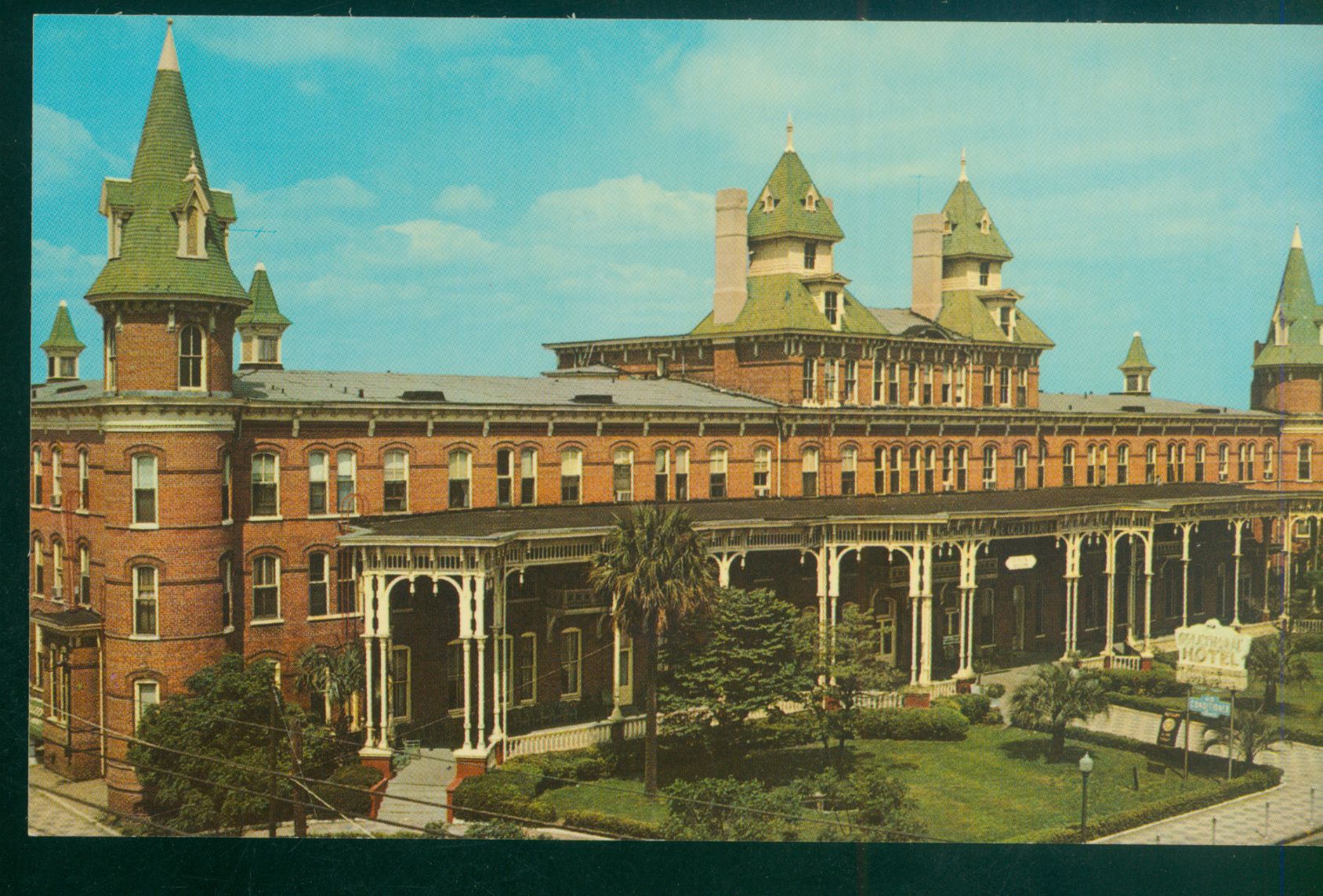 a large brick building with green roofs