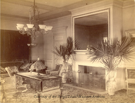 a room with a fireplace and a chandelier