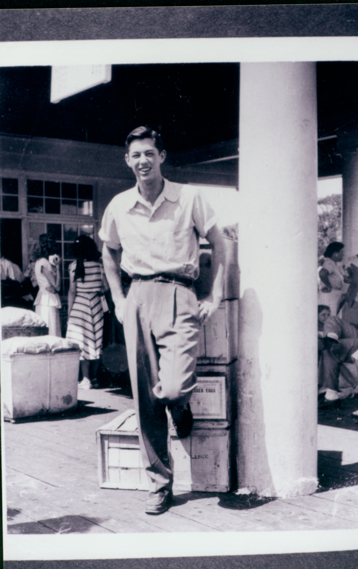 a man leaning against a pillar