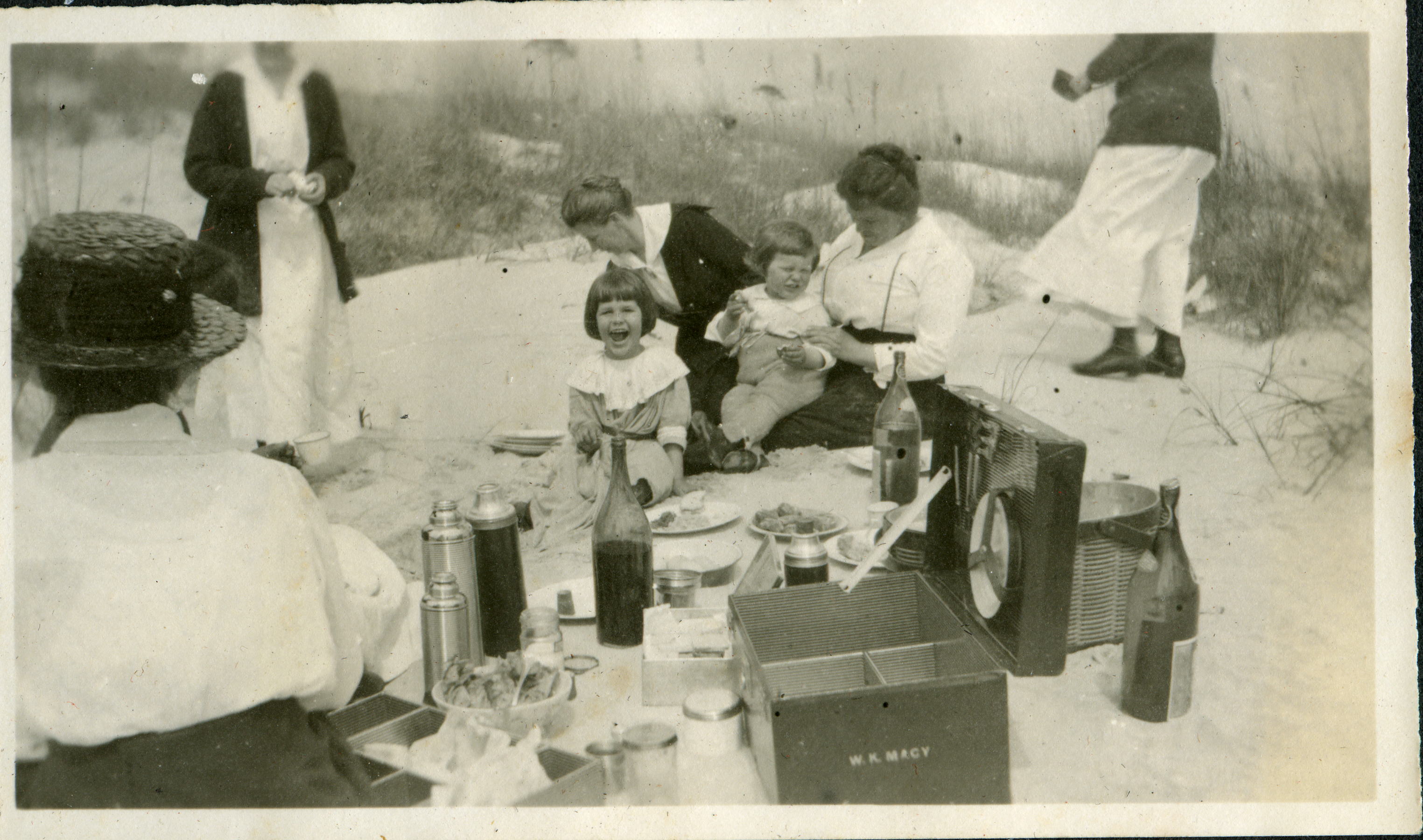a group of people sitting on a picnic table