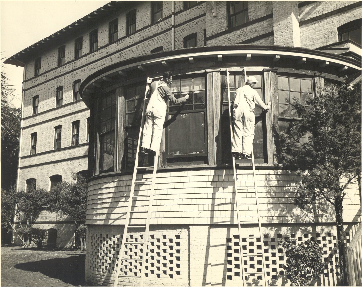 men on ladders on a building
