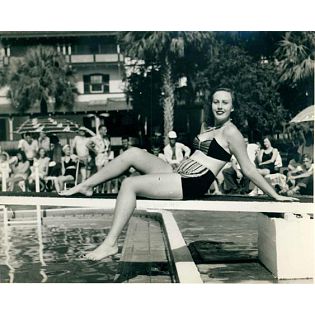 a woman sitting on a pool edge