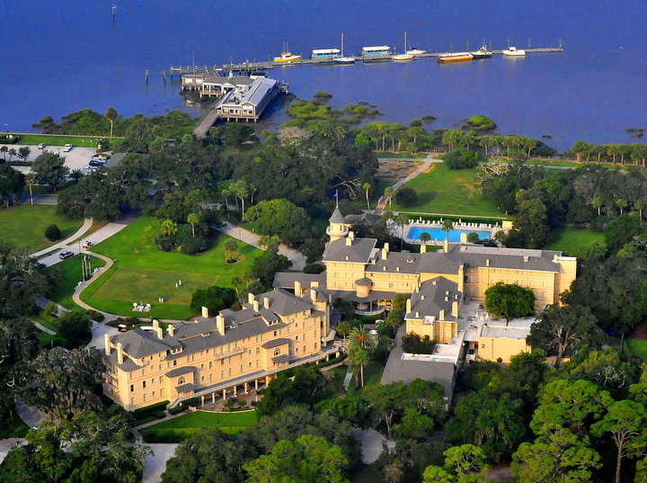 a large building surrounded by trees and water